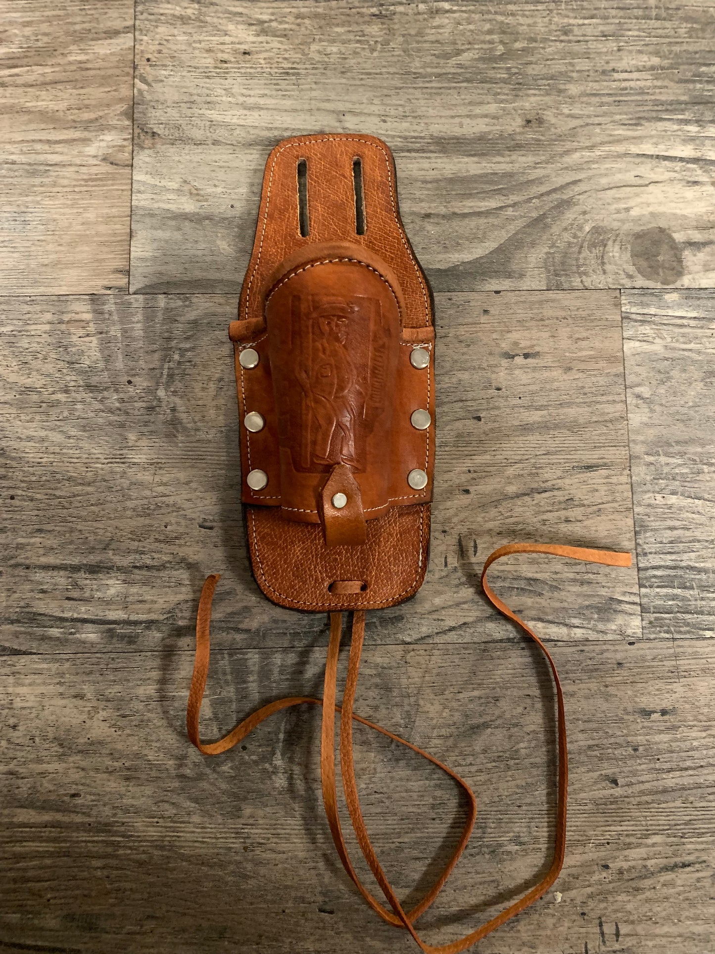 Leather Holder for Bottle Drinks

Tooled Leather Holder for Bottle Drinks. Attaches to your belt with slits...