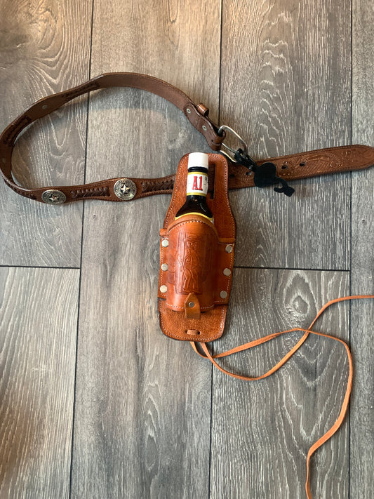 Leather Holder for Bottle Drinks

Tooled Leather Holder for Bottle Drinks. Attaches to your belt with slits...